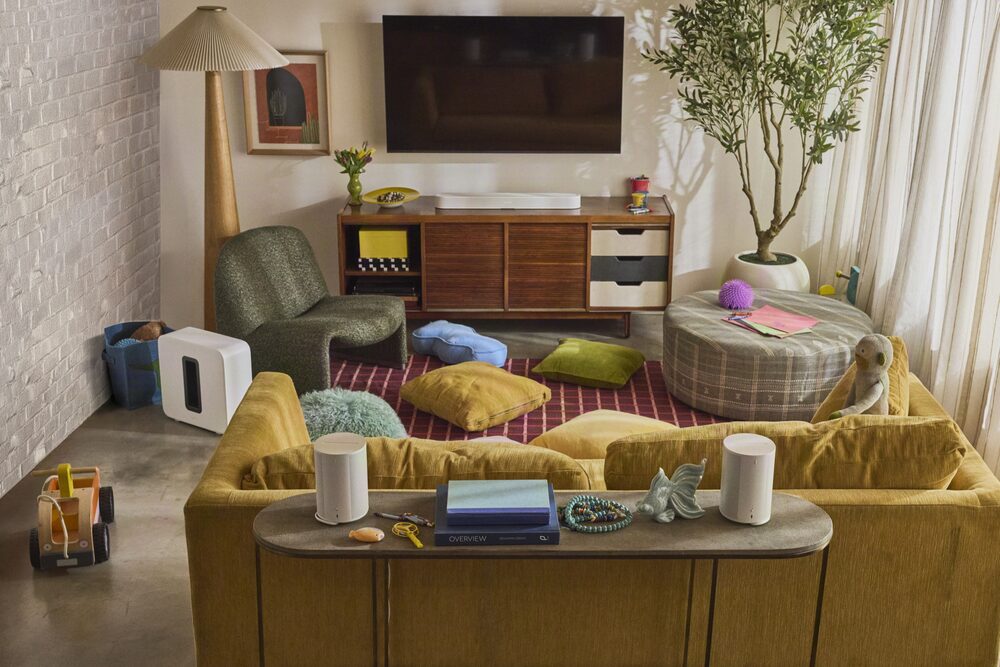 Colorful living room with Sonos speakers on a console behind the sofa