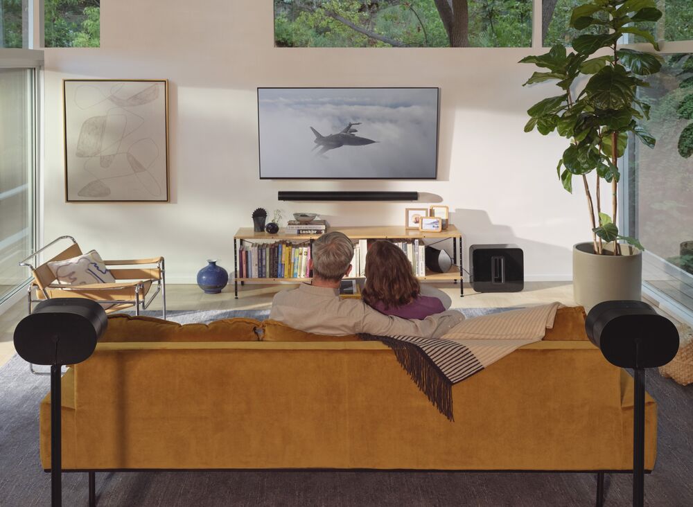 Living room home theater with a Sonos Arc Ultra soundbar, Sub and rear surround speakers on stands