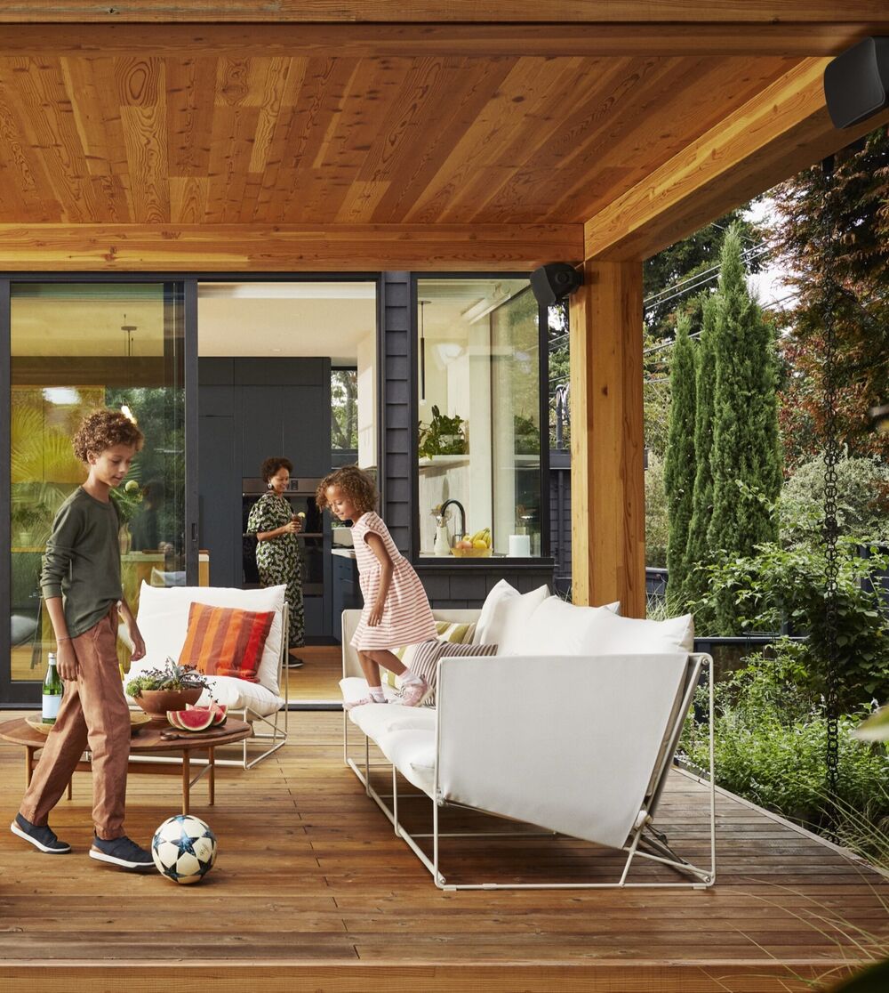 Covered outdoor patio with Sonos speakers mounted under the roof beams
